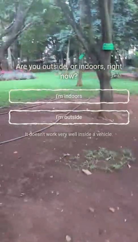 Camera view of a park with two hand-drawn buttons, I'm indoors and I'm outside, and a line reading it doesn't work very well inside a vehicle.